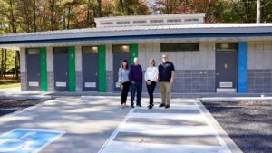 SLPC officials stand in front of newly constructed building
